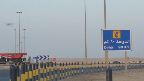 doha qatar border road sign